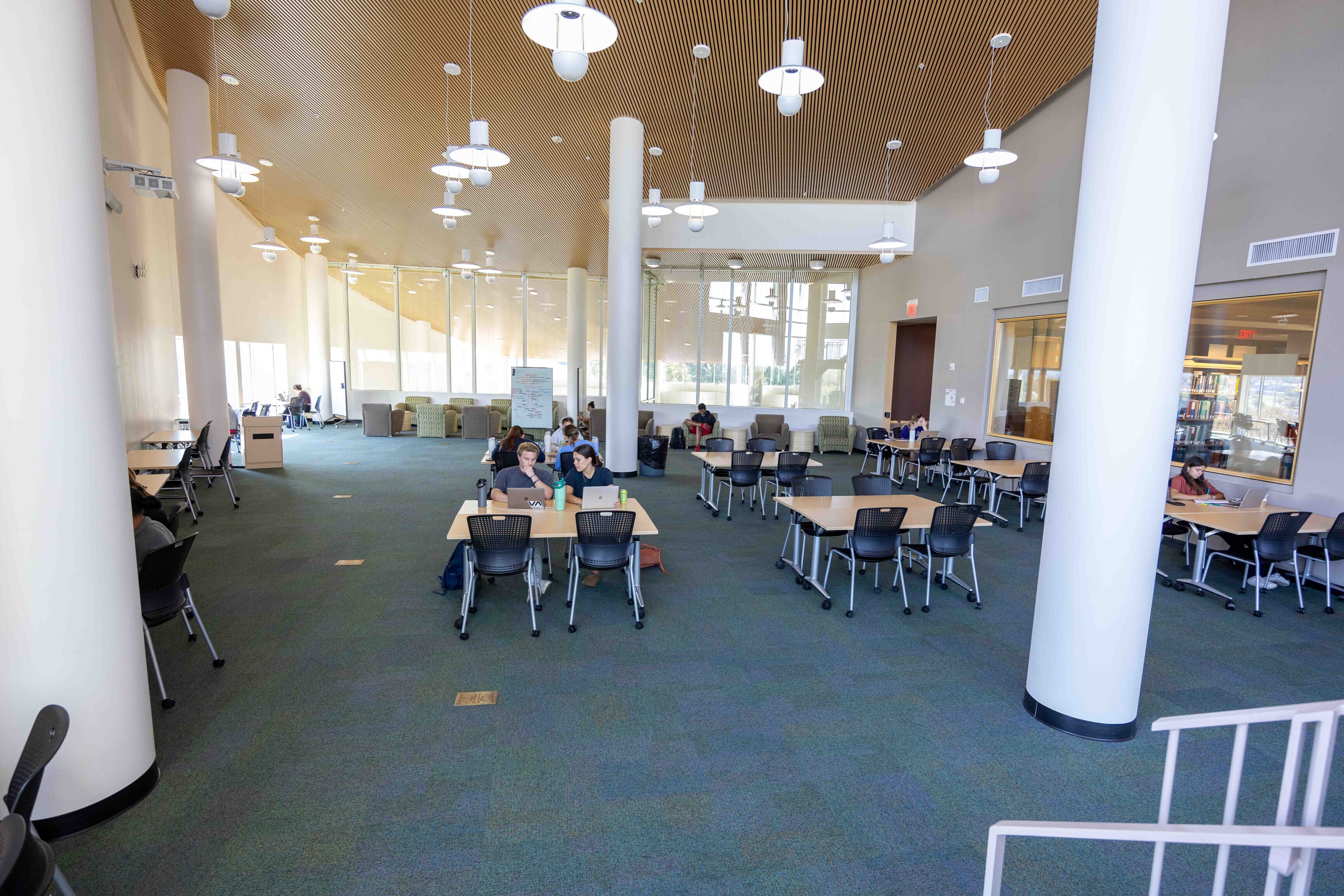 photo of Rose Library 3rd floor flex space, an open area with tables and rolling chairs